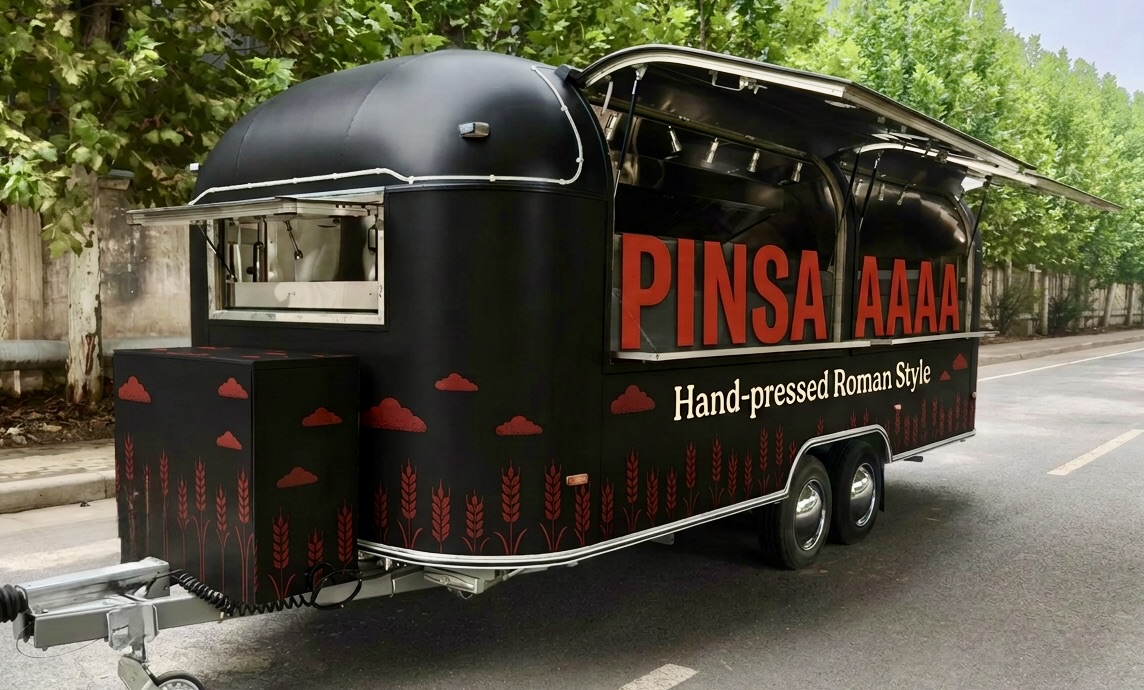 The black PINSAAAA Airstream trailer with full red wheat pattern and open serving hatches